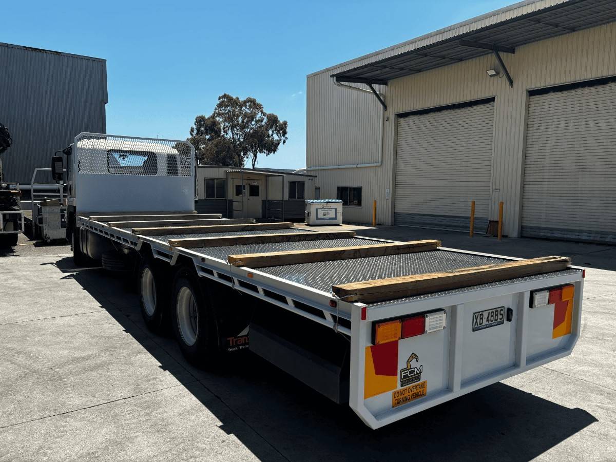 Rear view of customised FCM flatbed truck tray featuring timber runners built for heavy-duty use.