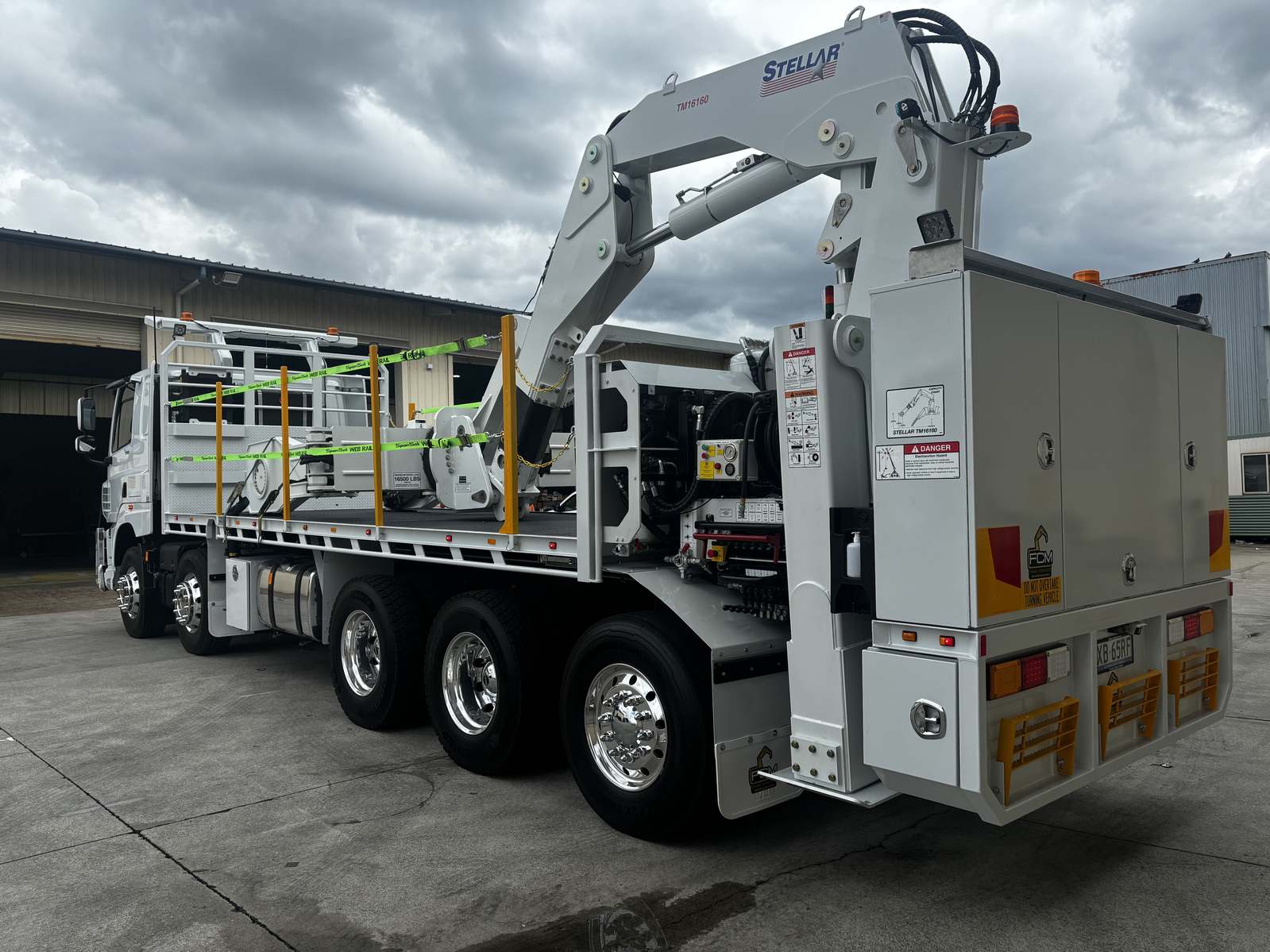 Stellar TM16160 tyre handler installed on white flatbed truck with FCM branding, safety railing and control cabinet.